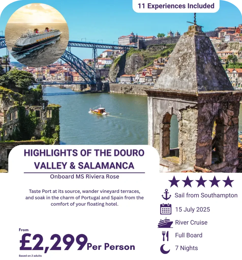 River cruise boat sailing through the scenic Douro Valley with historic Portuguese architecture